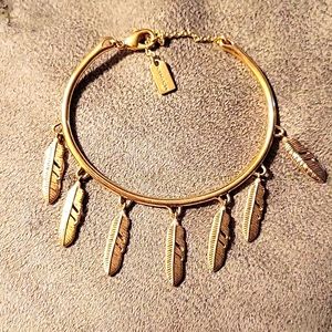 Gorgeous gold coach feather bracelet